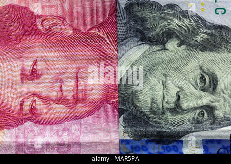 Close up of one hundred Dollar and 100 Yaun banknotes with focus on portraits of Benjamin Franklin and Mao Tse-tung/USA vs China trade war concept Stock Photo