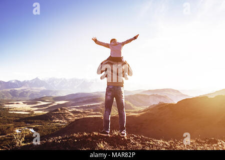 Father and son stands against mountains sunset and having fun. Fathers day concept Stock Photo
