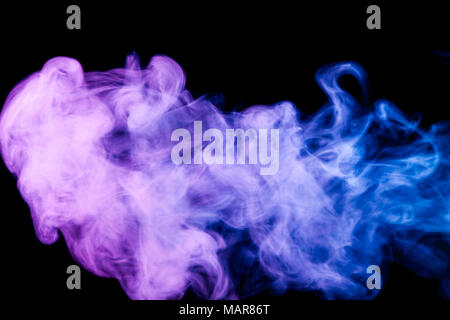 Dense  blue and purple multicolored smoke on a black isolated background. Background of smoke vape Stock Photo