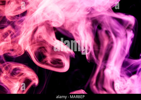 Thick colorful pink and purple smoke on a black isolated background. Background from the smoke of vape Stock Photo