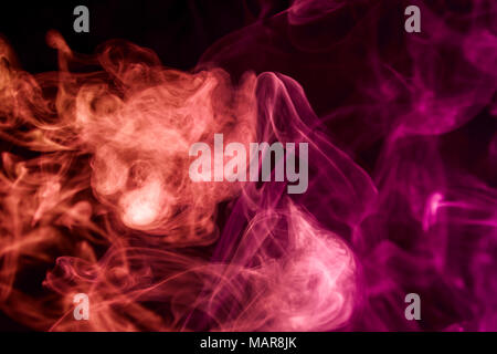 Red and   pink  smoke on black background Stock Photo