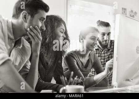 Working meeting in front of computer to share ideas on project Stock Photo