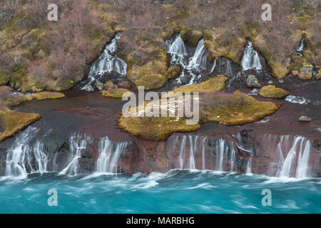 Waterfalls Hraunfossar pouring into the Hvita River. Iceland Stock Photo