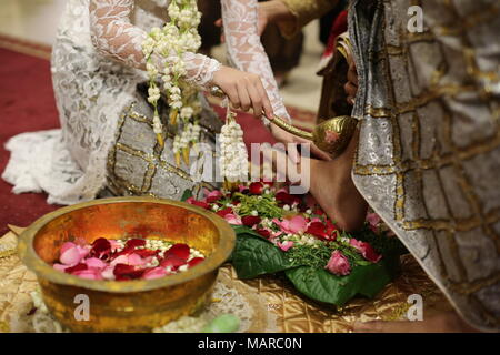 A Bride Washing Groom's Feet Traditional Indonesian Javanese Wedding Ceremony in Jogjakarta Stock Photo