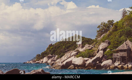 Costline of Koh Tao Islands in Thailand. Granite Rocks and blue clear water hitting Rocks Stock Photo