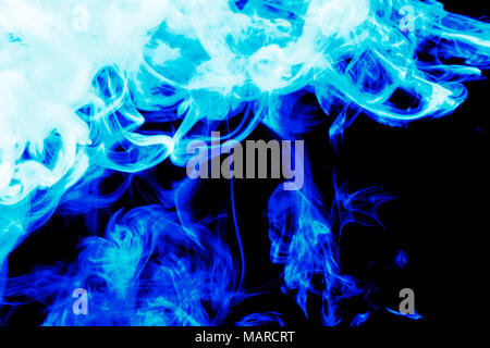 Cloud of  blue smoke on a black isolated background. Background from the smoke of vape Stock Photo