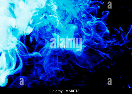 Cloud of  blue smoke on a black isolated background. Background from the smoke of vape Stock Photo