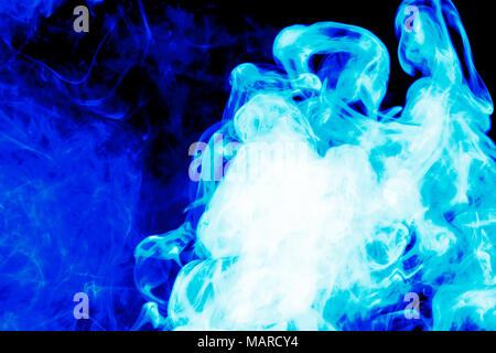 Dense blue smoke on a black isolated background. Background of smoke vape Stock Photo