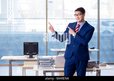 Young handsome businessman employee working in office at desk Stock Photo