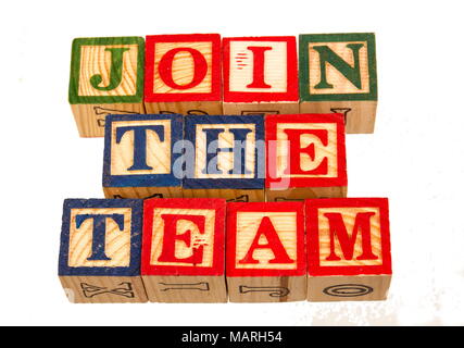 The term join the team displayed visually on a white background using colorful wooden toy blocks image with copy space in landscape format Stock Photo