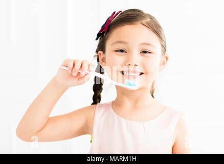 happy little girl brushing her teeth Stock Photo