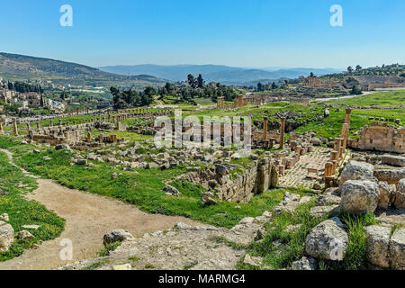 Roman ruins in Jerash, Jordan. The ancient ruins coexist with the modern city of Jerash and serve as a peaceful place to spend some quiet time alone. Stock Photo