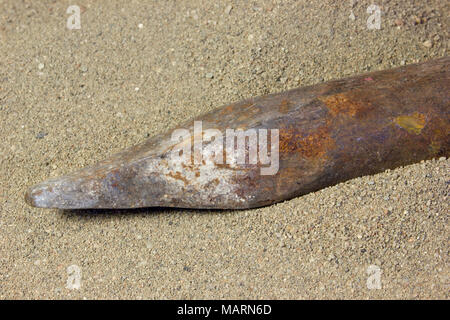 Old steel crowbar on the sand Stock Photo