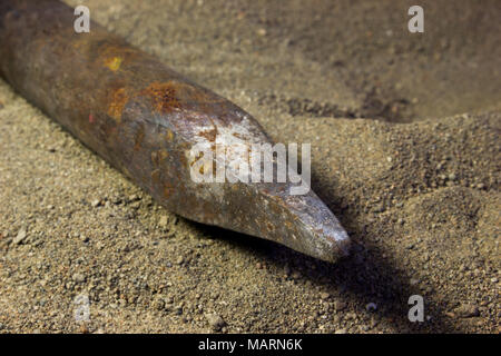 Old steel crowbar on the sand Stock Photo