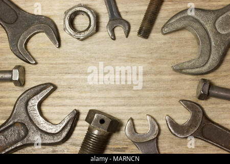 Wrench, nuts and bolts on wooden background Stock Photo