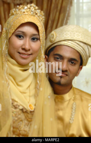 Malay couple in traditional wedding costume Stock Photo