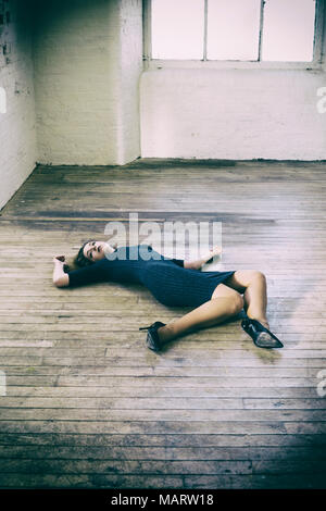 Dead woman laying down on the floor Stock Photo