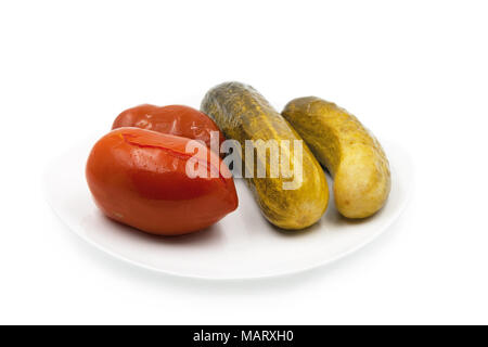 Pickled cucumbers and tomatoes. Isolated on white background. Stock Photo