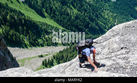 mountain guide on a steep rock face in the Swiss Alps near Maienfeld on a free solo ascent Stock Photo