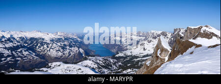 panorama view of winter mountain landscape with turquoise lake and surrounding snow-capped peaks Stock Photo