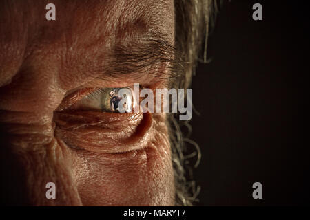 Half face of aggressive man looking with hatred into camera, domestic tyrant Stock Photo