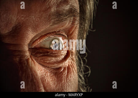 Half face of aggressive man looking with hatred into camera, domestic tyrant Stock Photo