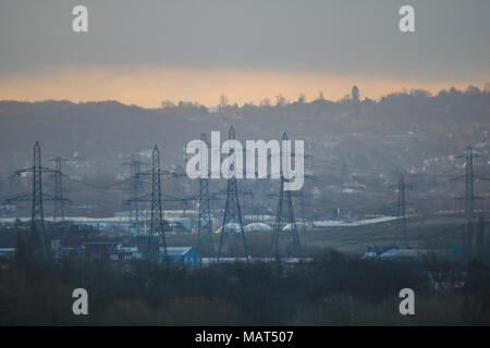 London UK. 4th April 2018. The sun breaks through behind Electricity pylons  on a bright morning sunrise in Wimbledon  after the heavy rainfall as the Met Office forecasts warm temperatures  across many parts of Britain Credit: amer ghazzal/Alamy Live News Stock Photo