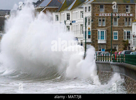 Penzance, Cornwall, UK. 4th April 2018.  A fast moving late winter storm brings waves as high as three storey hotels to the south west coast as Britain struggles to move properly in to Spring. Credit Mike Newman/Alamy Live News Stock Photo