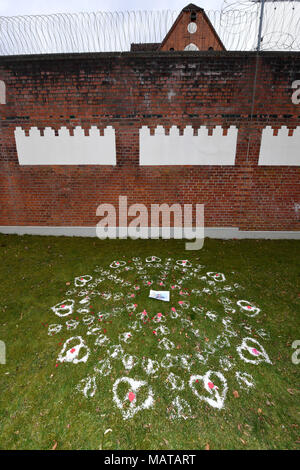 04 April 2018, Germany, Neumuenster: Hearts made of sand, stones and flowers and a portrait of former Catalan Regional President Carles Puigdemont decorate the lawn outside the correctional facility. Photo: Carsten Rehder/dpa Stock Photo