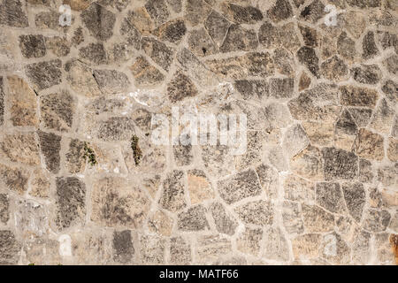 Old, white to creamy coloured rock wall texture for backgrounds (horizontal). Stock Photo