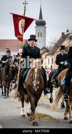 Easter Rider carrying a flag/banner while taking part in the sorbian tradional Easter Procession in Ralbitz, Lausitz, Germany Stock Photo