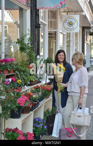 Two women browsing a florist display, south street, Eastbourne, East Sussex, England, UK Stock Photo