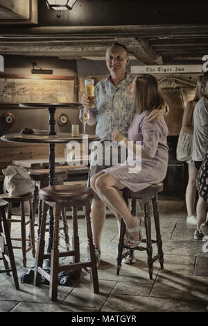 A couple inside The Tiger Inn, East Dean, East Sussex, England, UK Stock Photo