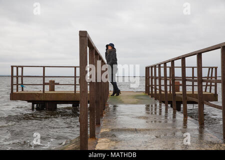 City Riga, Latvia. Women looking to the baltic sea. Standing on iron bridge. urban city view. Travel photo 2016 Stock Photo