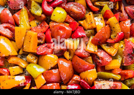 Baking tray with roasted bell peppers and tomatoes. Stock Photo