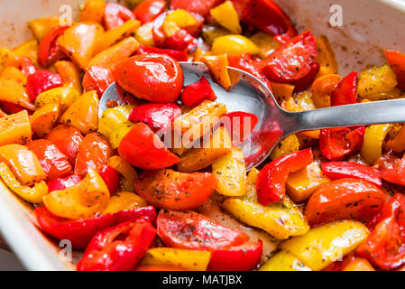 Baking tray with roasted bell peppers and tomatoes. Stock Photo