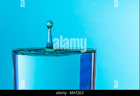 water drop splash in a glass of drinking water Stock Photo