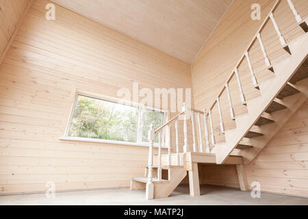 Empty wooden house interior with stairway and window Stock Photo