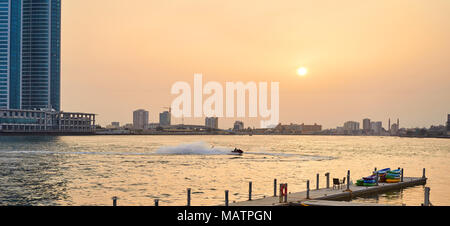 jet ski racing in the Bay at sunset Stock Photo