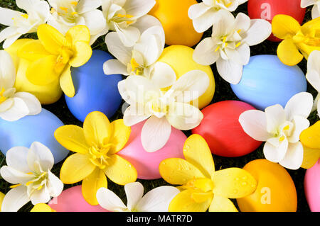 Easter background with hand painted eggs hidden in flowers Stock Photo