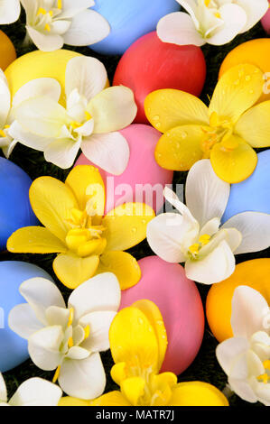 Easter background with hand painted eggs hidden in flowers Stock Photo