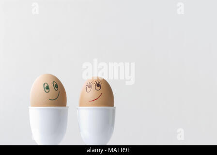 Two eggs in love.  Space on right for copy. Stock Photo