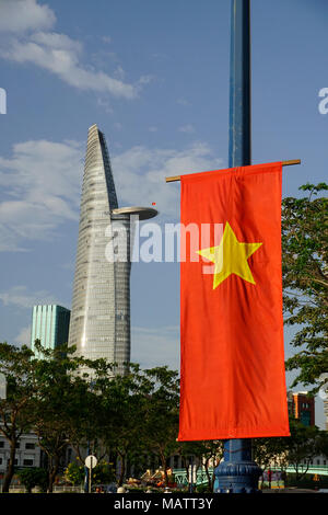 District One area, Ho Chi Minh City, Vietnam. The Bitexco Financial Tower. Designed by Carlos Zapata. Vietnamese flag in foreground. Stock Photo