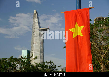 District One area, Ho Chi Minh City, Vietnam. The Bitexco Financial Tower. Designed by Carlos Zapata. Vietnamese flag in foreground. Stock Photo