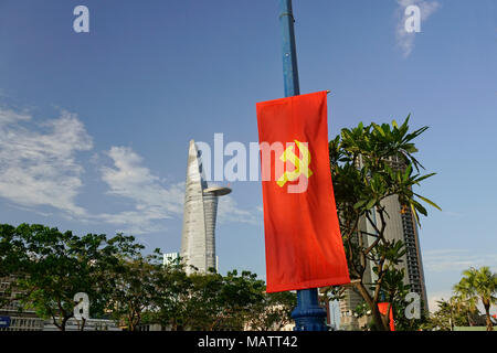 District One area, Ho Chi Minh City, Vietnam. The Bitexco Financial Tower. Designed by Carlos Zapata. Communist flag in foreground. Stock Photo