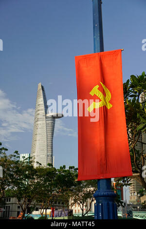 District One area, Ho Chi Minh City, Vietnam. The Bitexco Financial Tower. Designed by Carlos Zapata. Communist flag in foreground. Stock Photo