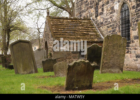 Ancient Escomb Church, and wonky tombstones, graveyard, in County Durham, one of the oldest in the UK and founded in 7th century Stock Photo