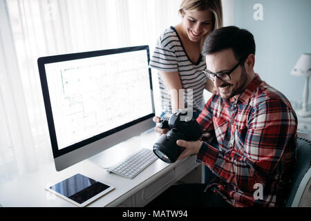 Young attractive designers working on project together Stock Photo