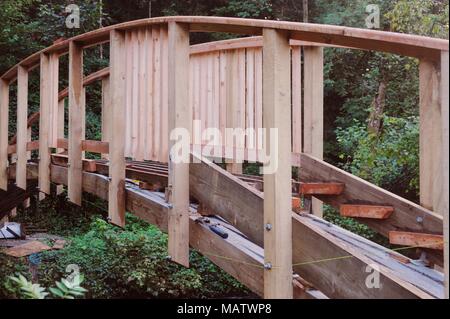 7 in a series of 32, building a timber footbridge. Lifting the complete ...