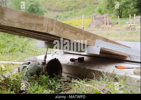 12 in a series of 32, building a timber footbridge. Fixing the steel end  support brackets. Stock Photo